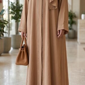 Mocha beige abaya with delicate embellishment along the front and sleeve cuffs, paired with a matching beige hijab | Azmira Collection