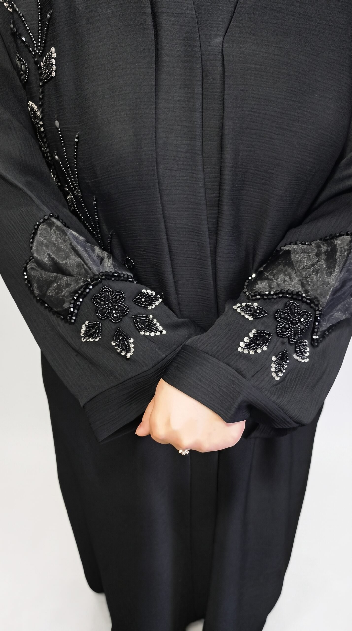 Black embroidered abaya with intricate floral detailing on the front and sleeves, paired with a matching hijab | Azmira Collection